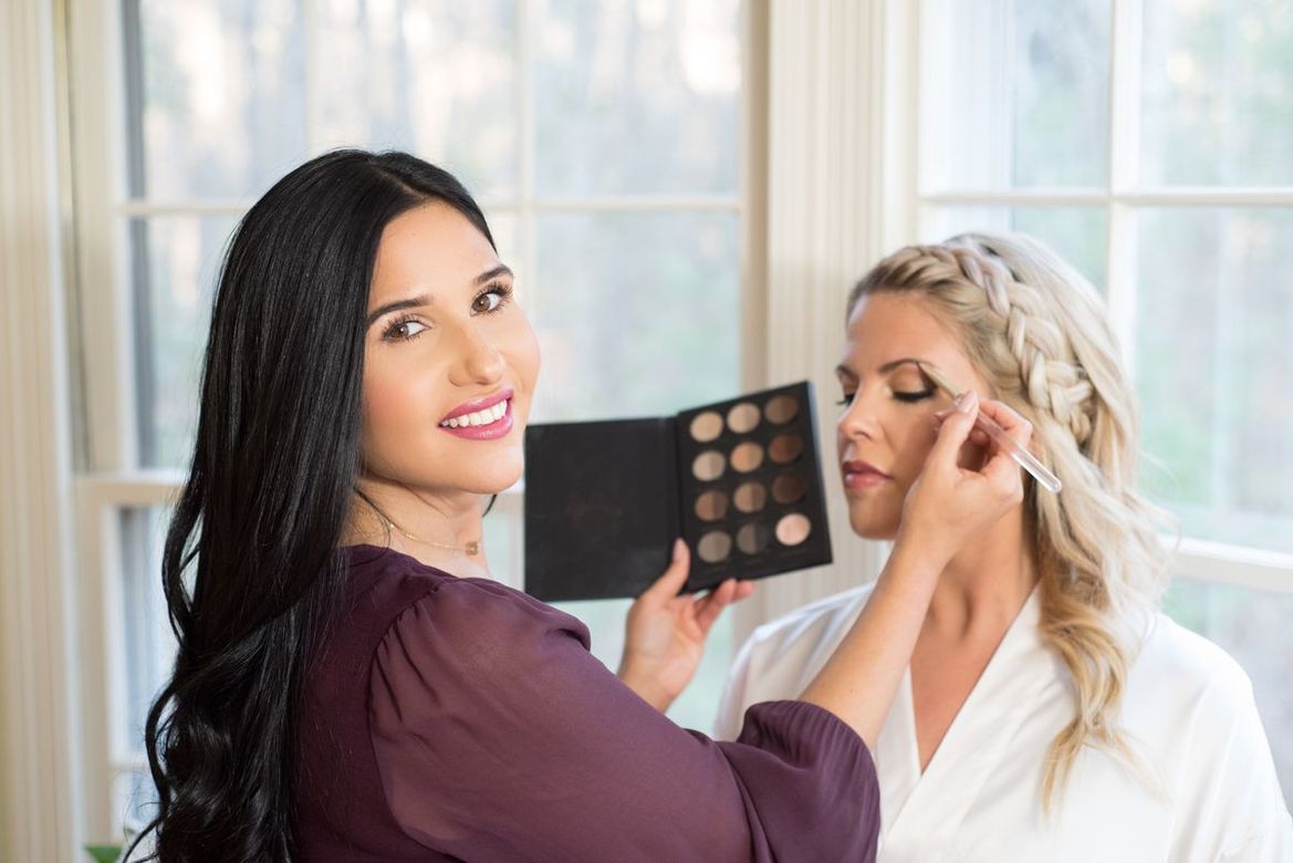 Makeup Artist Amy Kimberly putting eyeshadow on woman